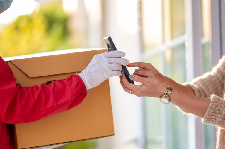 Young women sign to pick up the goods through the smart phone,courier service concept